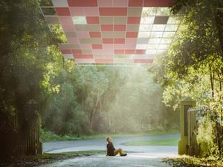 Man sitting on the ground and acoustic ceiling in the sky stairing up at