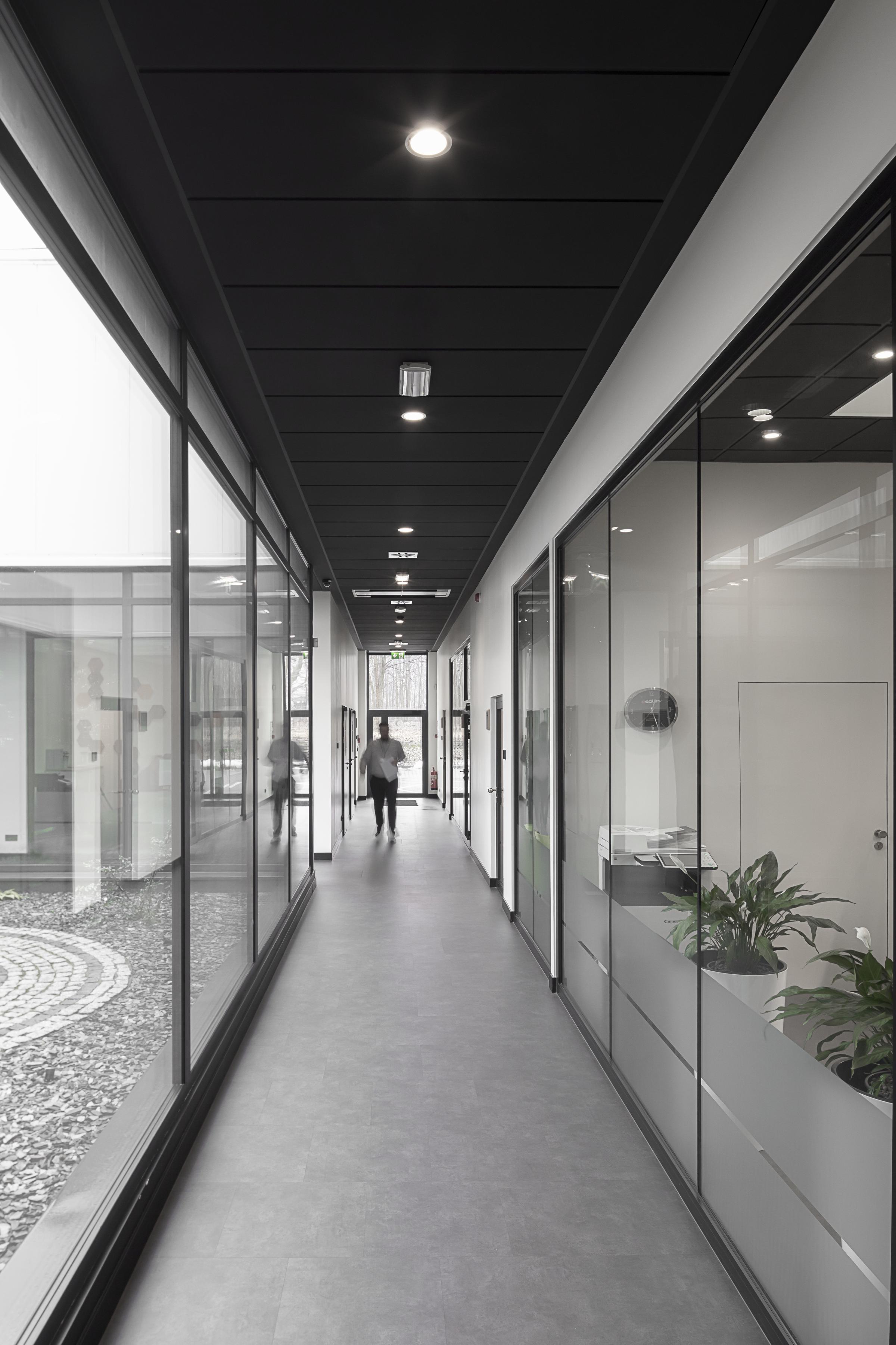 Black acoustic ceiling in office corridor