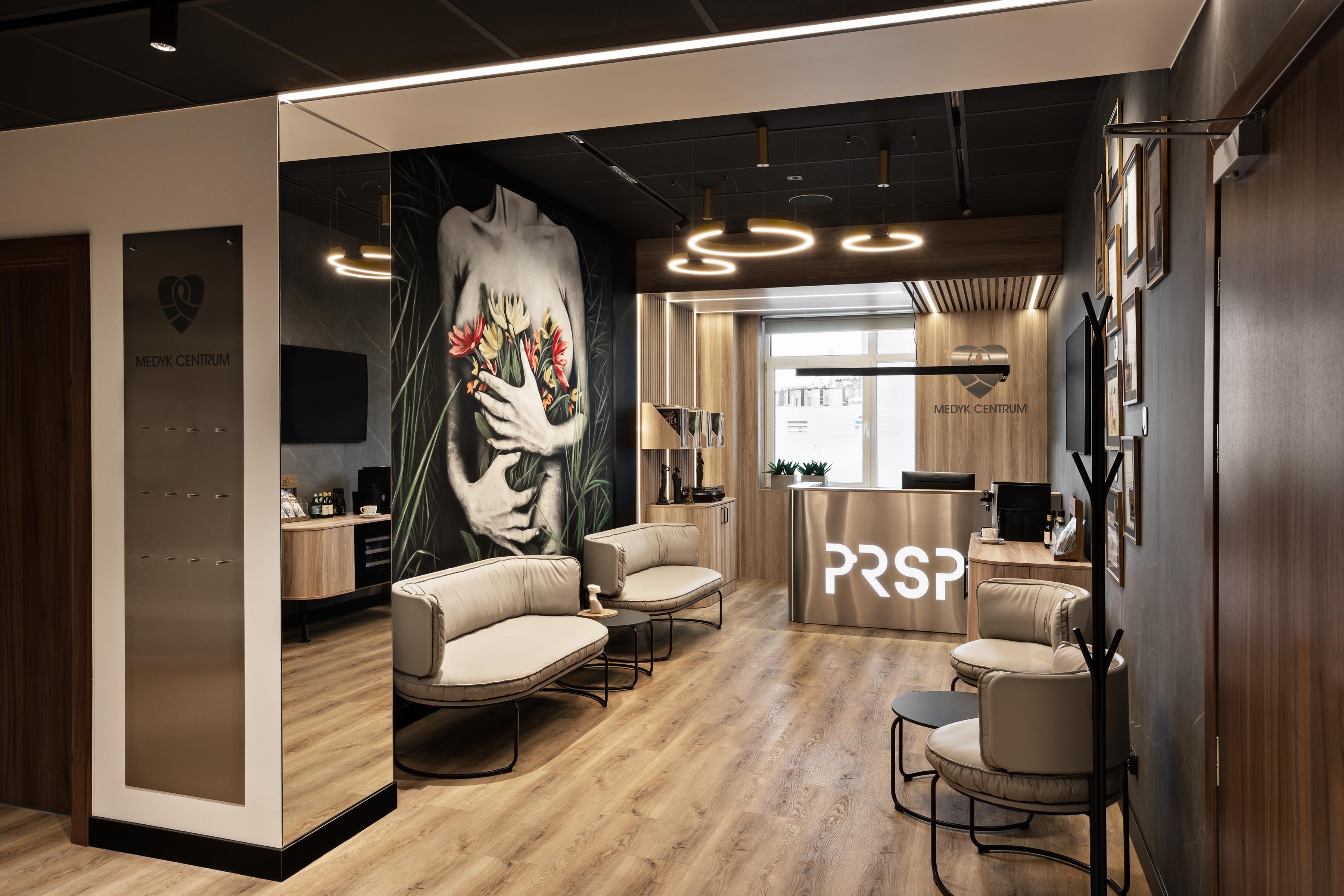 Black, suspended acoustic ceiling in reception area of a plastic surgery clinic