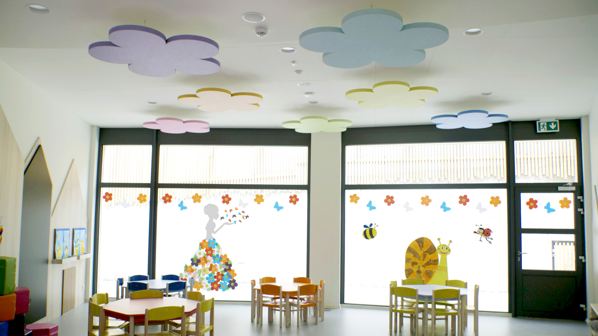 Acoustic free-hanging ceiling panels in the shape of clouds in kindergarten