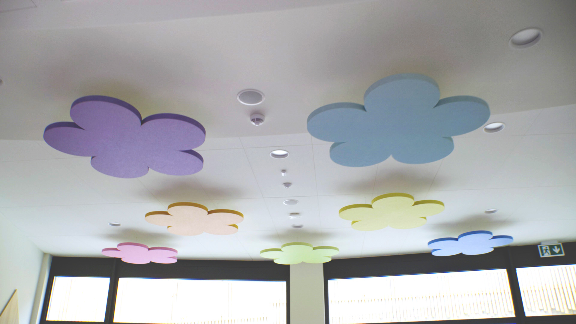 Acoustic free-hanging ceiling panels in the shape of clouds in kindergarten