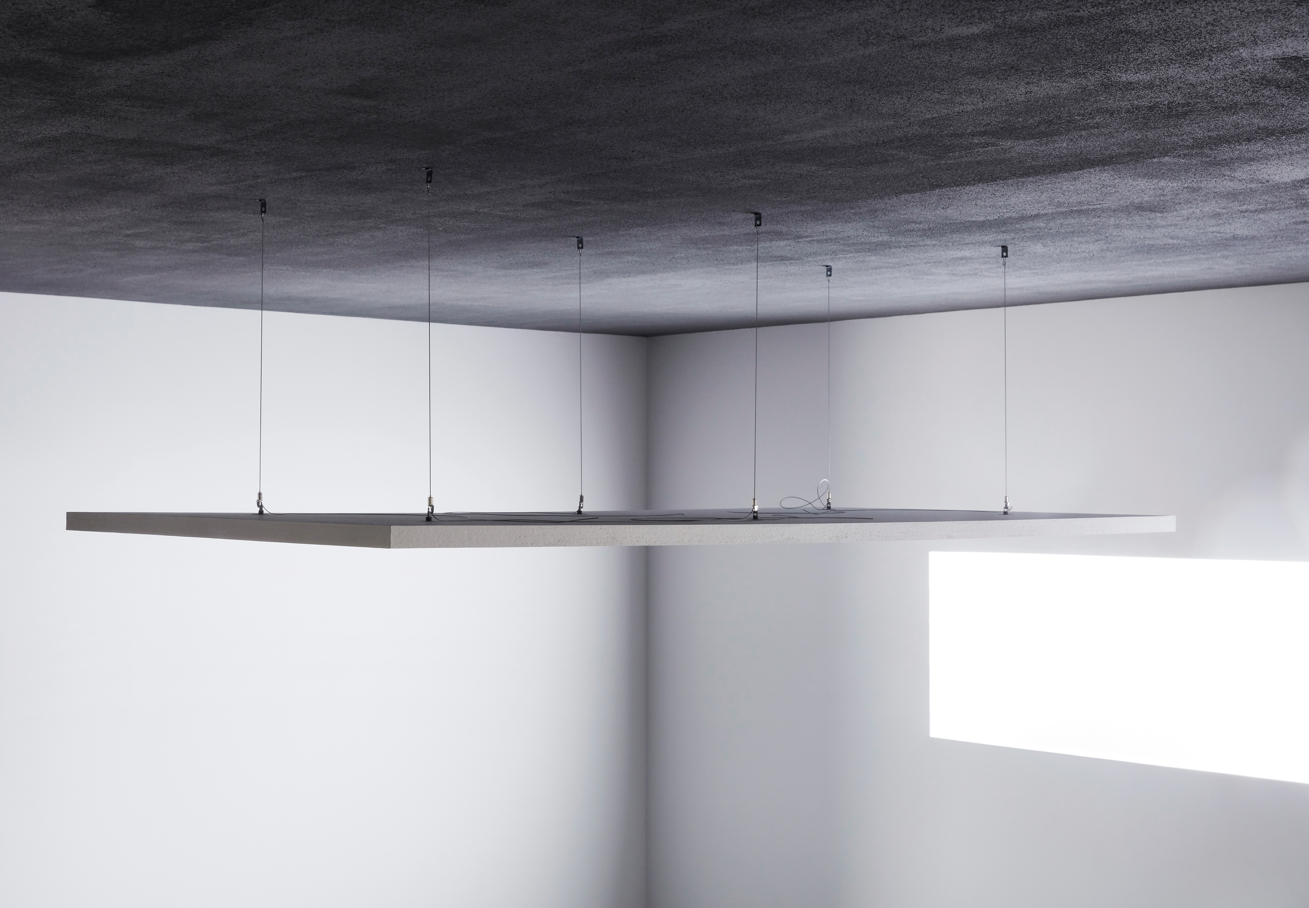 Free-hanging acoustic panel installed with height adjustable wires